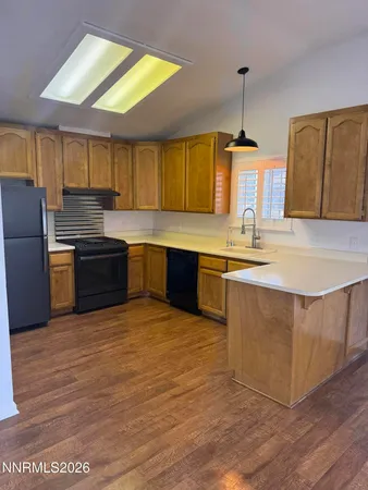 a kitchen with stainless steel appliances granite countertop a sink counter space cabinets and a window