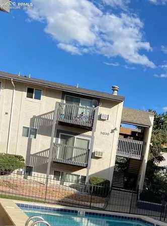 a view of a white building with glass windows