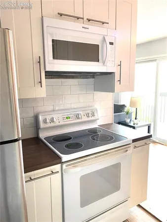 a stove top oven sitting inside of a kitchen