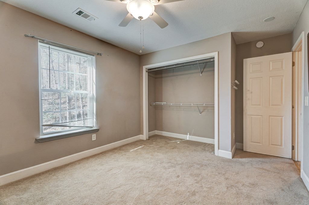 104 Nugget Lane Ellijay, GA 30540 - Photo 11 of 36 an empty room with windows and closet