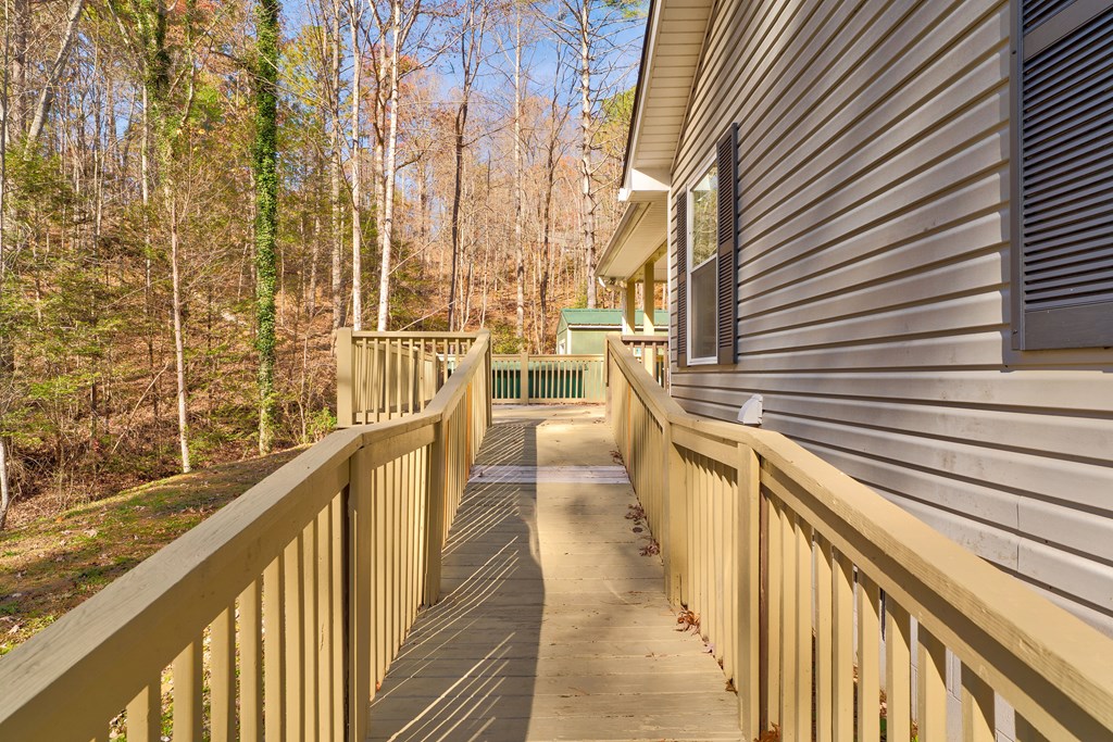 104 Nugget Lane Ellijay, GA 30540 - Photo 20 of 36 a view of a balcony with floor to ceiling windows with wooden floor
