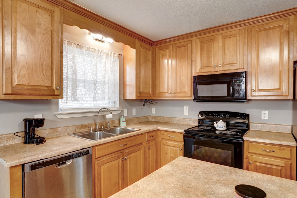 104 Nugget Lane Ellijay, GA 30540 - Photo 29 of 36 a kitchen with granite countertop a sink stainless steel appliances and cabinets