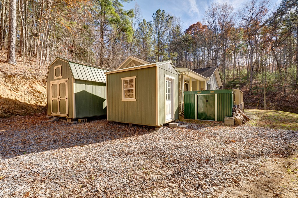 104 Nugget Lane Ellijay, GA 30540 - Photo 8 of 36 a view of a grey house with a yard and large tree