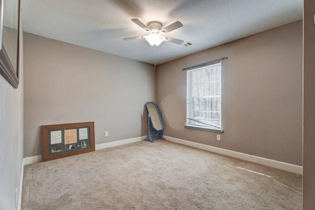 104 Nugget Lane Ellijay, GA 30540 - Photo 10 of 36 a view of a livingroom with a ceiling fan and window