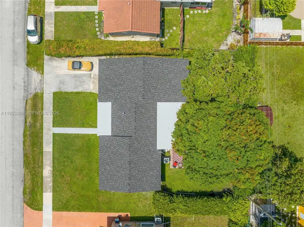 an aerial view of a house with a yard