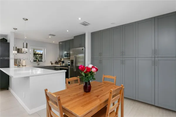 a dining room with furniture and flowers