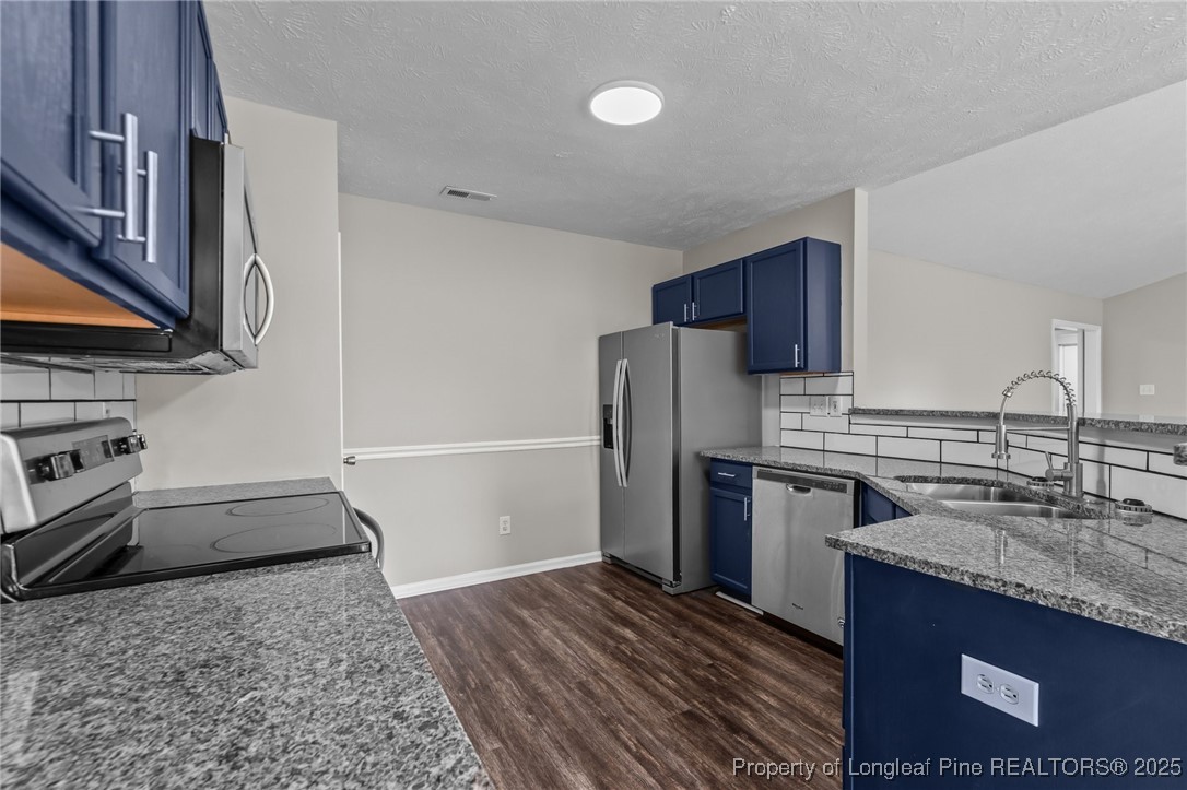 124 Quail Ridge Drive Raeford, NC 28376 - Photo 15 of 39 a kitchen with a sink stove and refrigerator