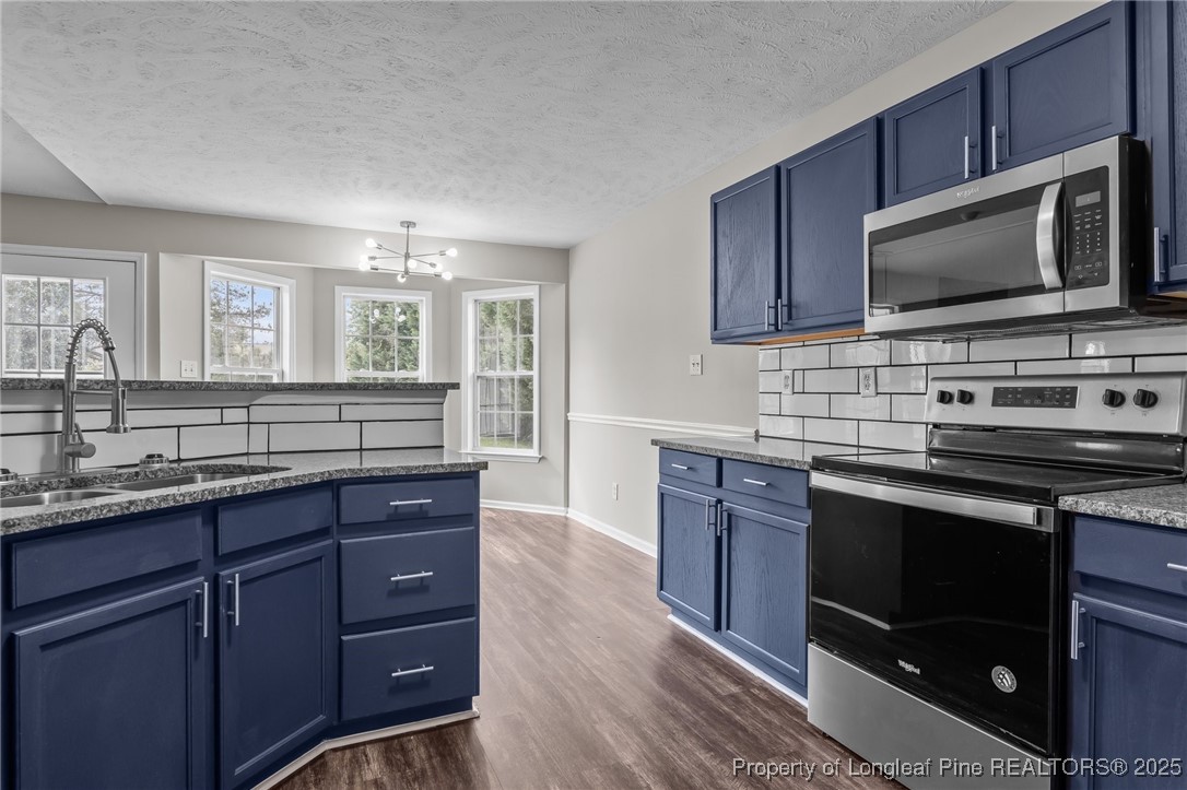124 Quail Ridge Drive Raeford, NC 28376 - Photo 17 of 39 a kitchen with wooden cabinets and stainless steel appliances