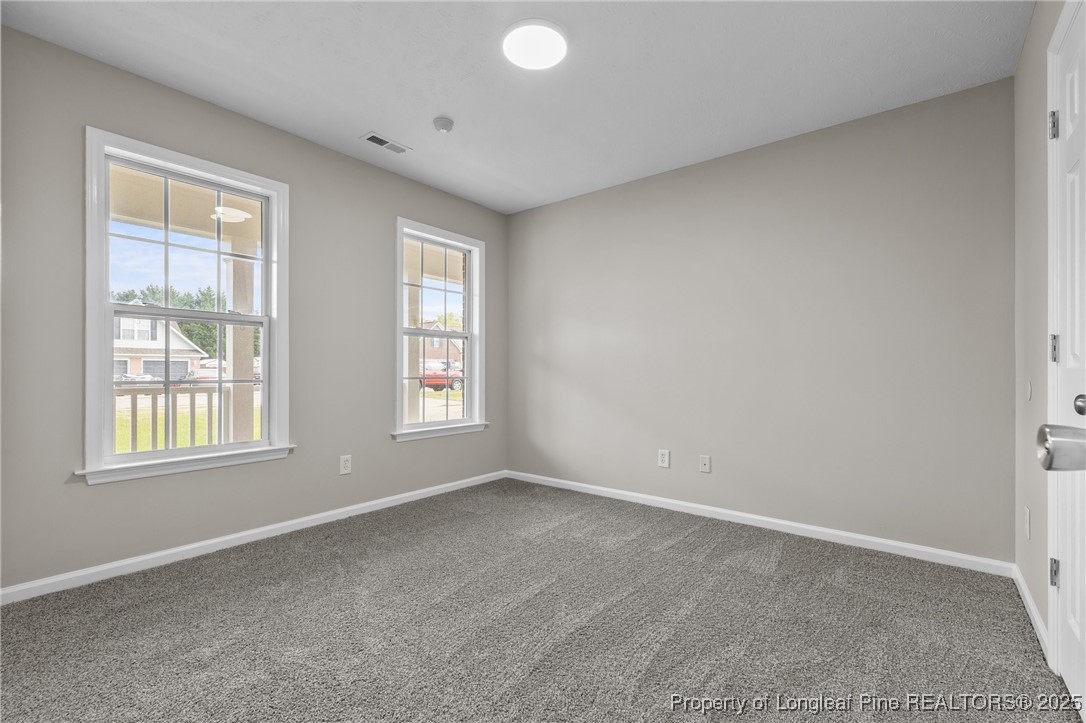 124 Quail Ridge Drive Raeford, NC 28376 - Photo 24 of 39 an empty room with windows