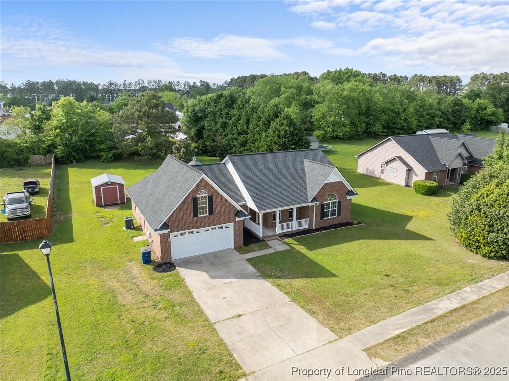 124 Quail Ridge Drive Raeford, NC 28376 - Photo 36 of 39 a aerial view of a house with swimming pool and a yard