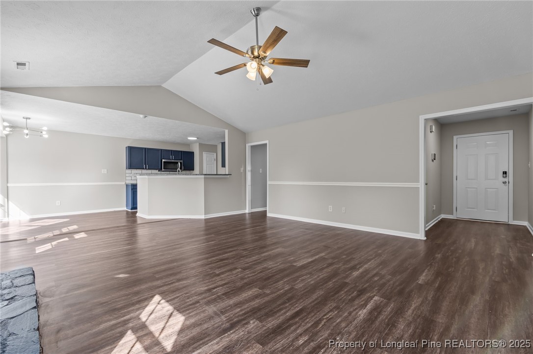 124 Quail Ridge Drive Raeford, NC 28376 - Photo 8 of 39 a view of an empty room with wooden floor and a ceiling fan