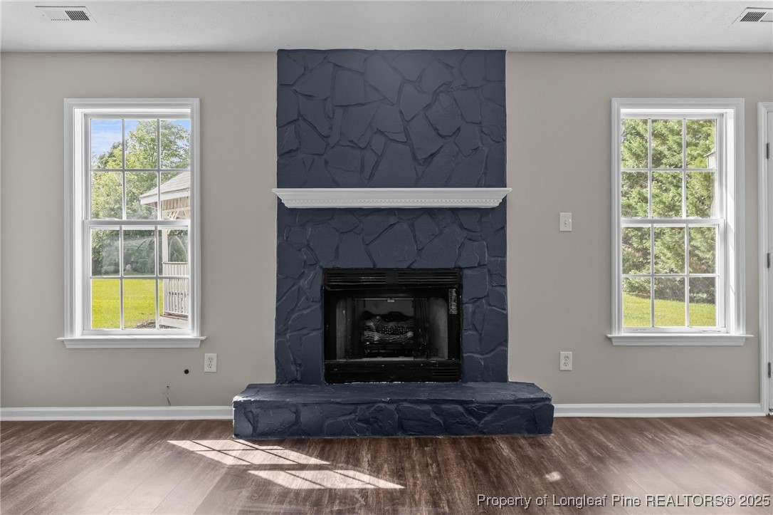 124 Quail Ridge Drive Raeford, NC 28376 - Photo 9 of 39 a living room with a fireplace and windows