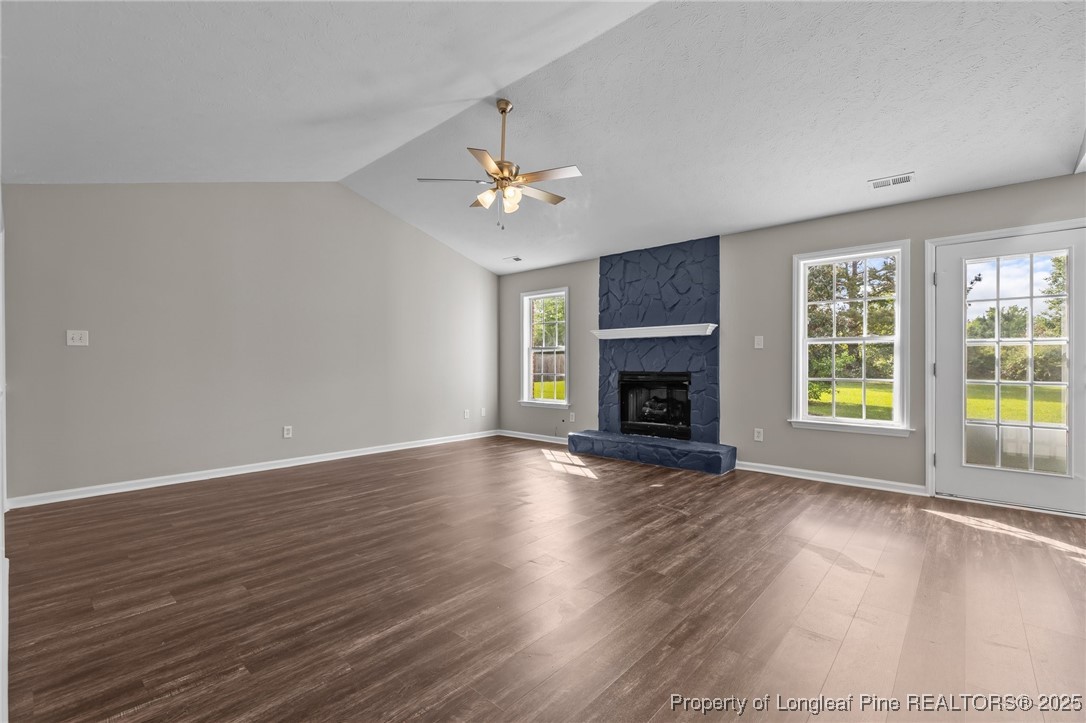124 Quail Ridge Drive Raeford, NC 28376 - Photo 10 of 39 a view of an empty room with wooden floor and a window