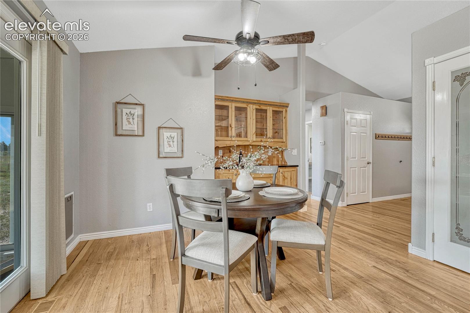 13695 Woodlake Road Elbert, CO 80106 - Photo 14 of 39 Dining area with oak floors and built-in hutch.