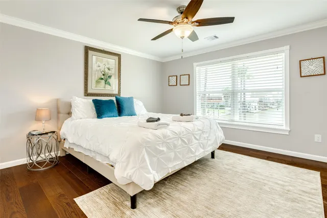 a bedroom with a large bed and a window