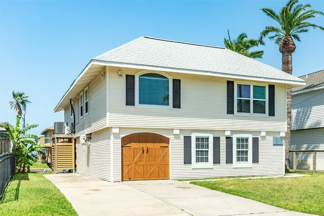 a front view of a house with a garden