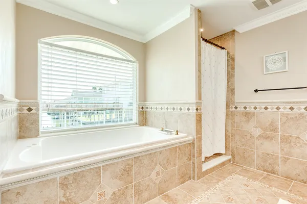 a spacious bathroom with a bathtub and a shower