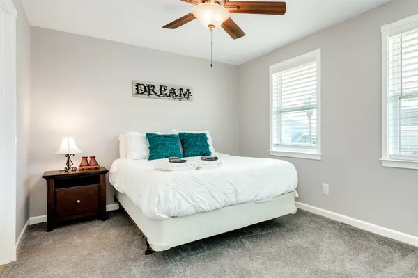 a bedroom with a bed and a chandelier