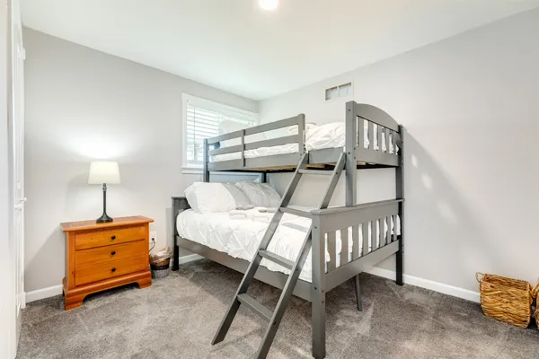 a bedroom with furniture and a window