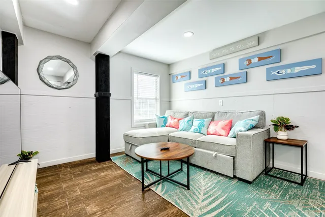 a living room with furniture and wooden floor