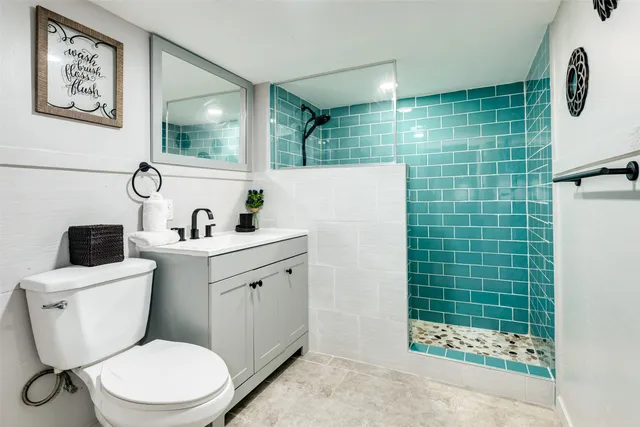 a bathroom with a toilet sink and shower