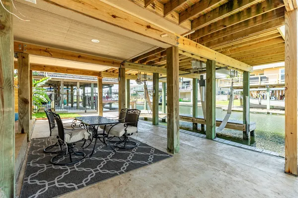 a dining room with furniture and a floor to ceiling window