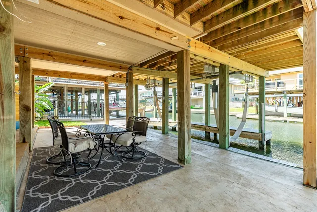 a dining room with furniture and a floor to ceiling window