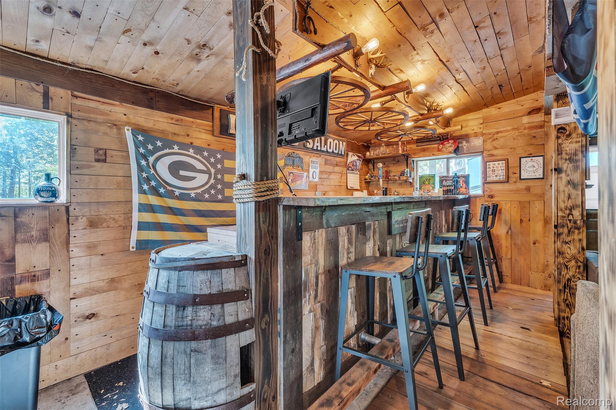 1345 Ives Road Mason, MI 48854 - Photo 55 of 92 Bar area with wooden walls, a vaulted wooden ceiling, and hardwood / wood-style flooring
