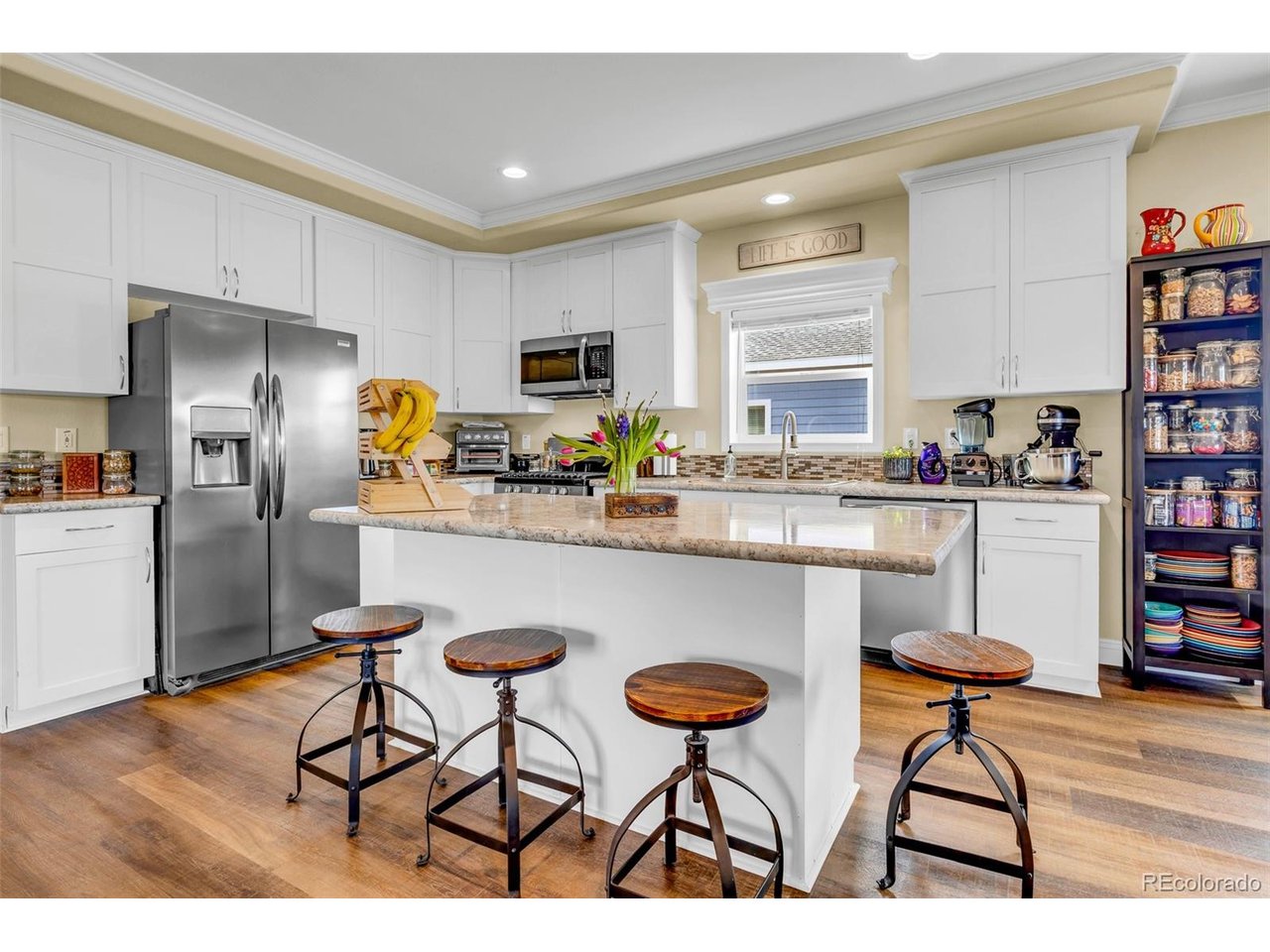 108 Sun Rock Road, Unit A Fairplay, CO 80440 - Photo 2 of 49 a kitchen with stainless steel appliances a dining table chairs refrigerator and sink