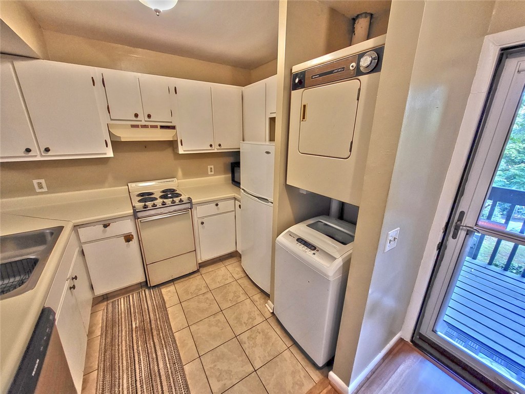 150 Ligon Street, Unit 1001 Clemson, SC 29631 - Photo 8 of 29 Functional kitchen offers essential appliances and direct access to an outdoor living space.