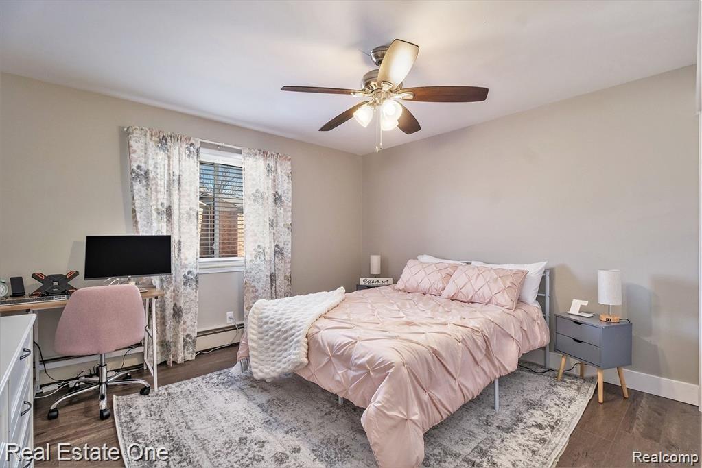 803 Plate Street, Unit 104 Rochester, MI 48307 - Photo 7 of 14 Room featuring wood-finish flooring, a ceiling fan with integrated lighting, and neutral wall tones