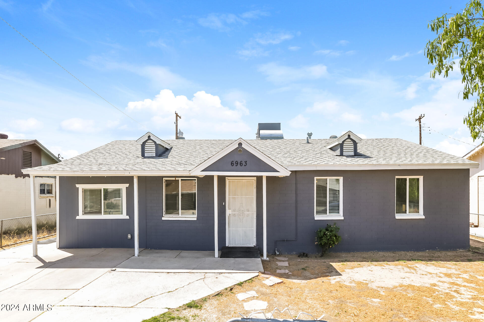 6963 West Pierson Street Phoenix, AZ 85033 - Photo 1 of 21 a front view of a house with a yard