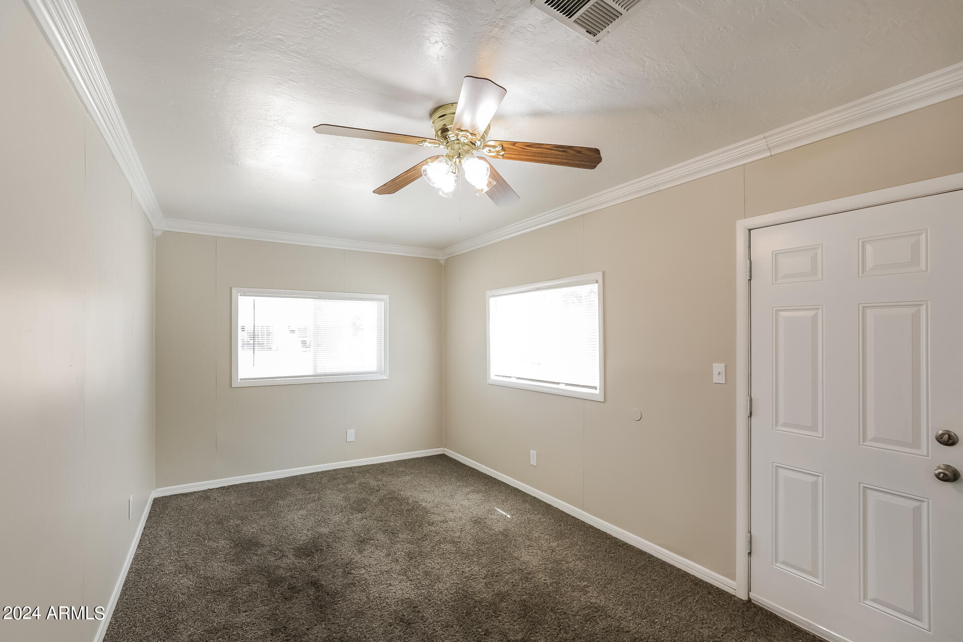 6963 West Pierson Street Phoenix, AZ 85033 - Photo 12 of 21 a view of a livingroom with a ceiling fan and window