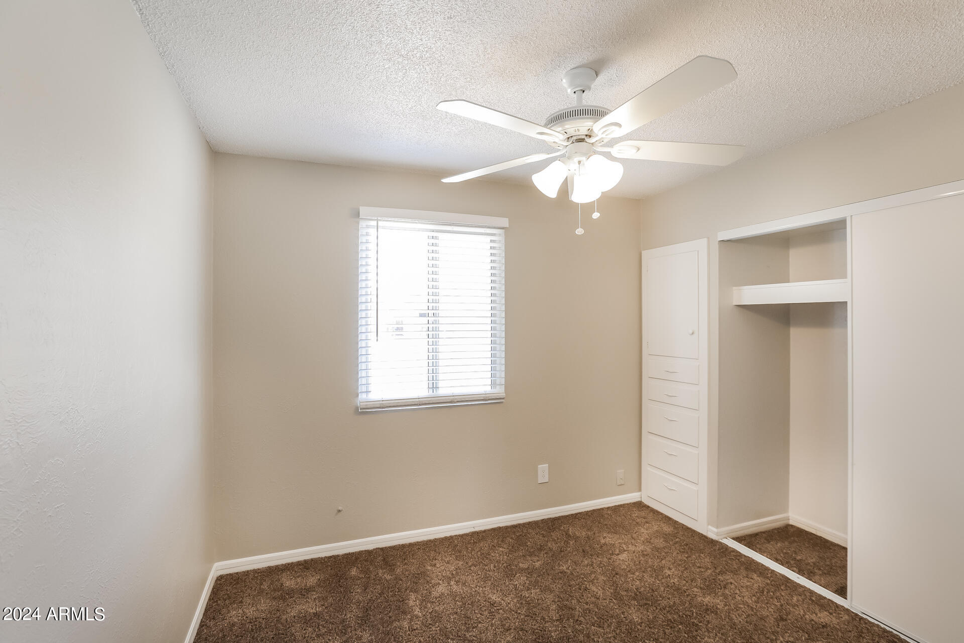 6963 West Pierson Street Phoenix, AZ 85033 - Photo 14 of 21 an empty room with windows and fan