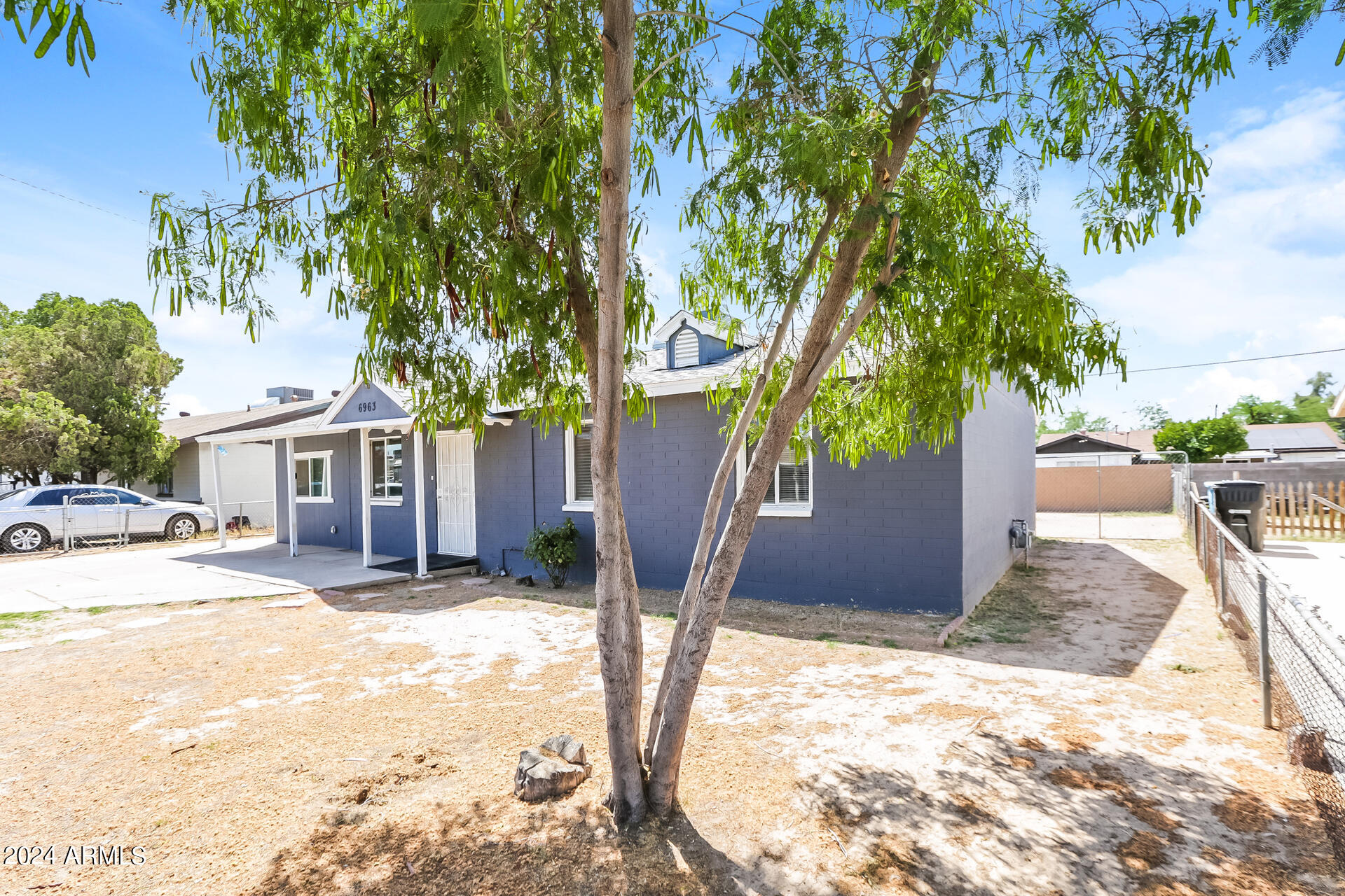 6963 West Pierson Street Phoenix, AZ 85033 - Photo 2 of 21 a view of a house with a yard and tree