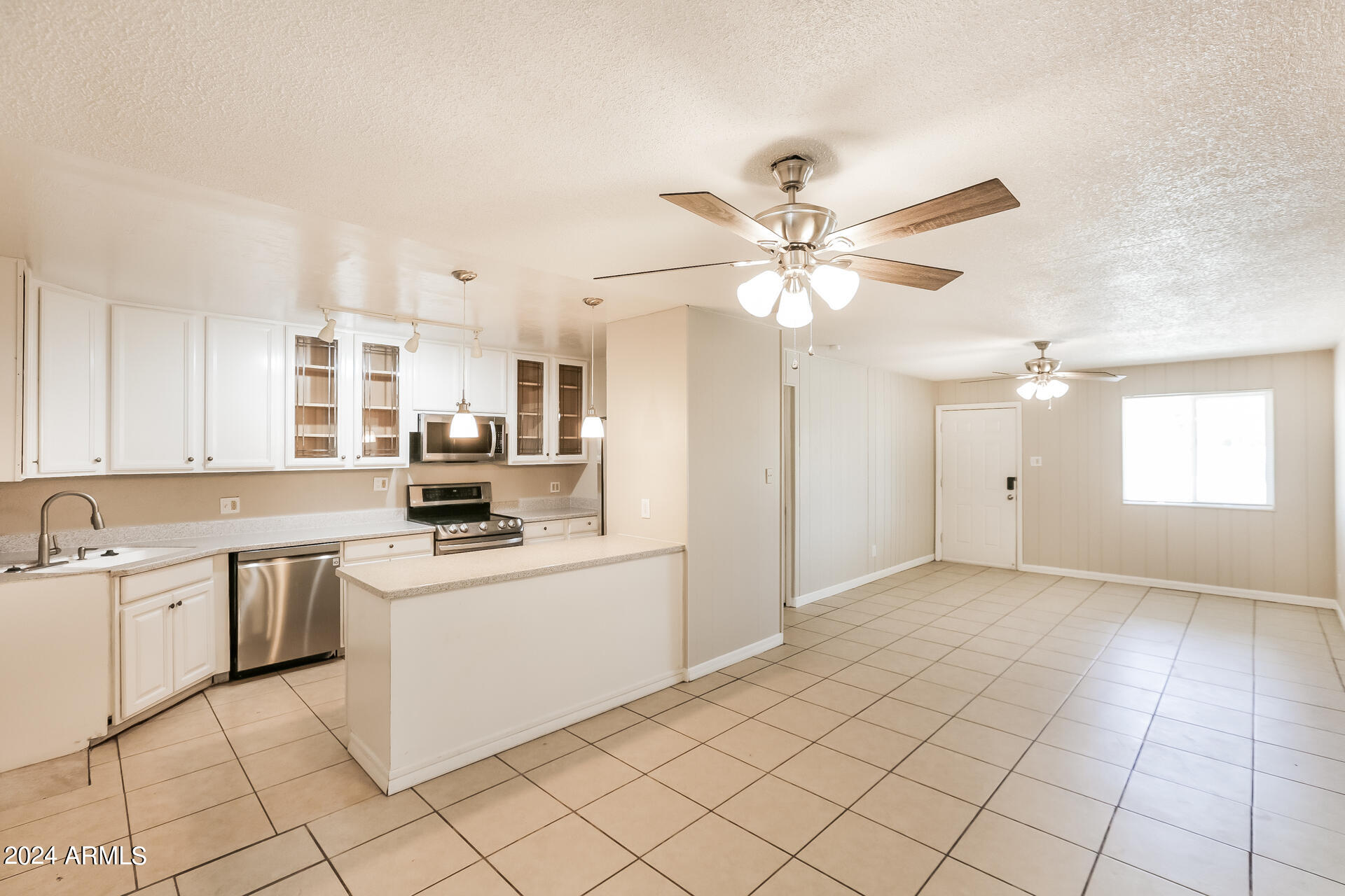 6963 West Pierson Street Phoenix, AZ 85033 - Photo 6 of 21 a kitchen with a sink cabinets and window