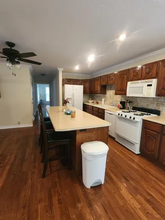 a view of a room with wooden floor and furniture
