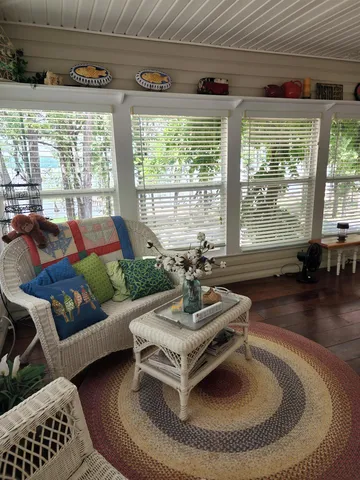 a bedroom with furniture and wooden floor