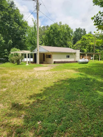 a view of a swimming pool with a yard and a fountain