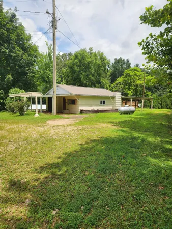 a swimming pool with outdoor seating and yard