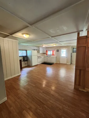 a big room with wooden floors and furniture