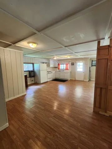 a big room with wooden floors and furniture