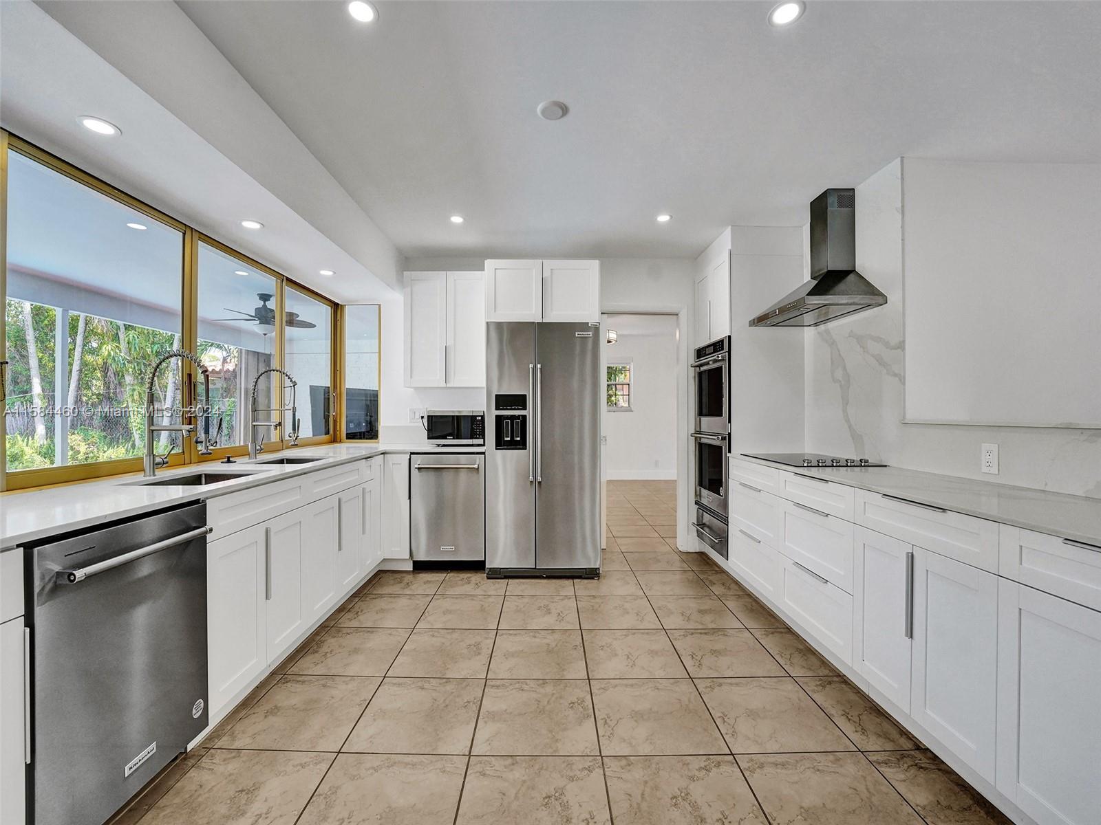 3460 North 46th Avenue Hollywood, FL 33021 - Photo 12 of 35 a kitchen with stainless steel appliances granite countertop a sink and stove