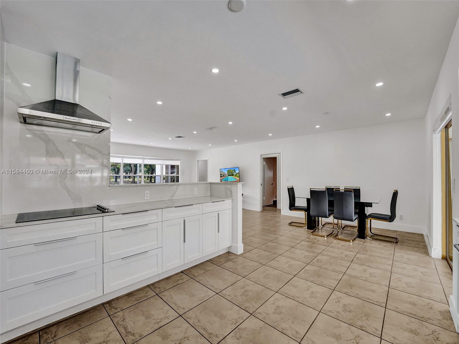 3460 North 46th Avenue Hollywood, FL 33021 - Photo 13 of 35 a kitchen with stainless steel appliances kitchen island granite countertop a sink and cabinets
