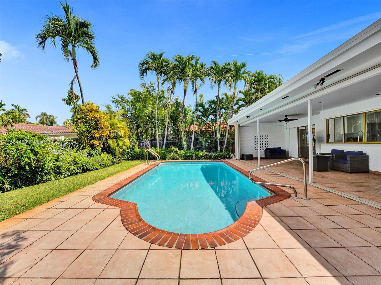 3460 North 46th Avenue Hollywood, FL 33021 - Photo 33 of 35 a view of a swimming pool with a lounge chair and a yard