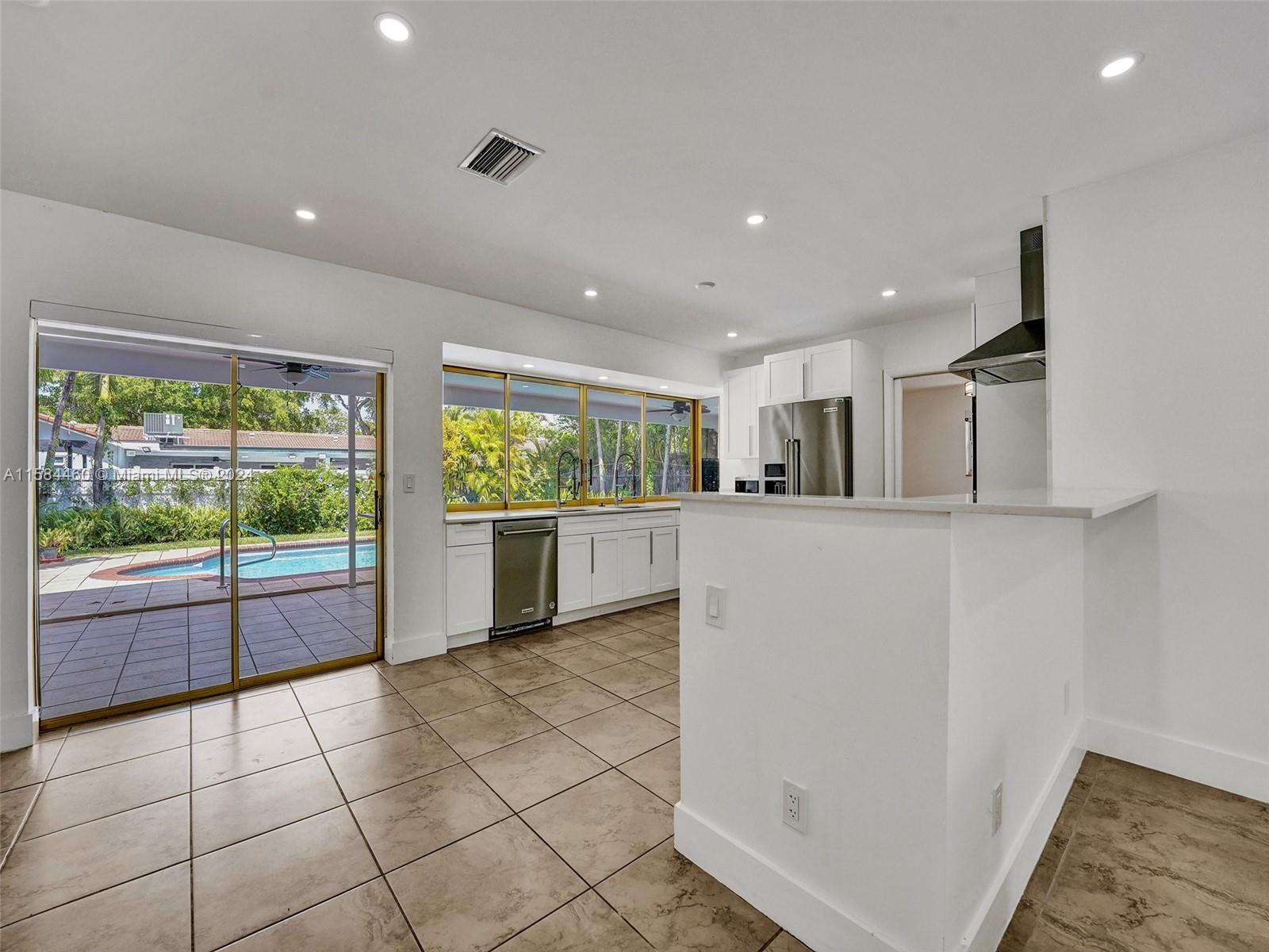 3460 North 46th Avenue Hollywood, FL 33021 - Photo 10 of 35 a view of a kitchen with furniture and an empty room