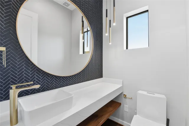 a bathroom with a toilet a sink and mirror