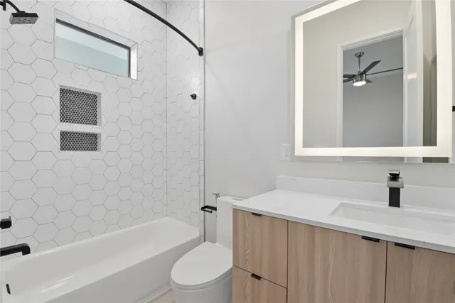 a bathroom with a sink a toilet and bathtub