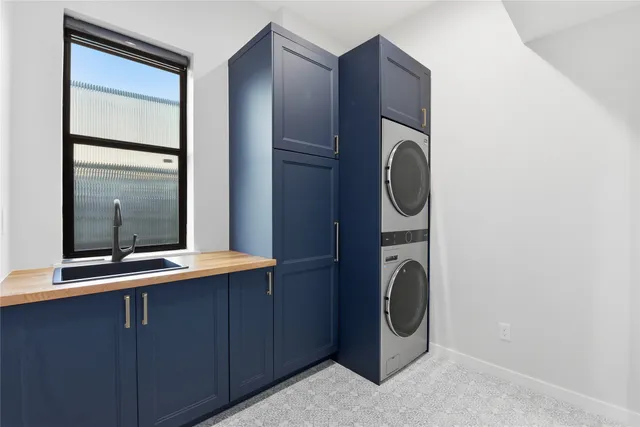 a utility room with sink dryer and washer