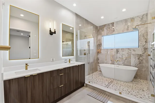a bathroom with a double vanity sink a mirror and a bathtub